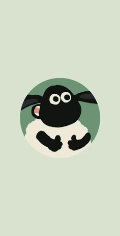 a black and white sheep sitting in the middle of a green circle with its eyes wide open