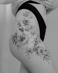 a woman's thigh with flowers on it