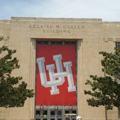 a large building with a giant red sign on it's side