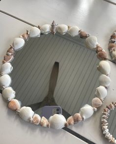 there is a mirror with seashells on it