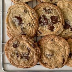 chocolate chip cookies on a cooling rack ready to be eaten by someone in the kitchen