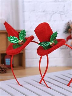 two red hats with holly leaves on them and the words look no further for the look you want