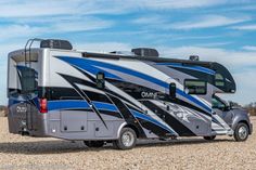 an rv parked on gravel in the desert