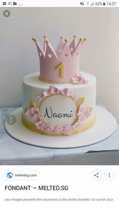 a white cake with pink frosting and a crown on top that says fondant - melted sg