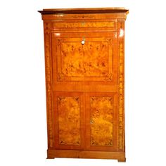 an antique wooden cabinet with two doors