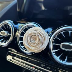 a close up of a car's emblem with a flower on the center piece