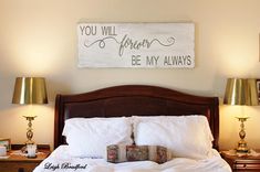 a bed with two lamps on either side and a sign above it that says you will always be my always