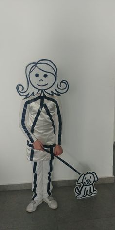 a person standing next to a white wall with a stick in it's hand