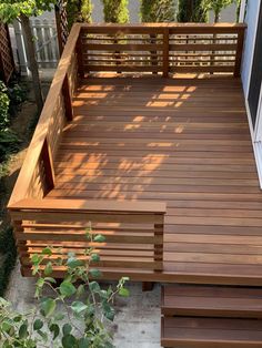 a wooden deck in the middle of a yard