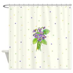 a shower curtain with purple flowers and polka dots on the bottom, in front of a white background