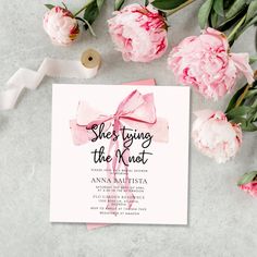 pink peonies and flowers are on the table next to this wedding card that says she's trying the knot