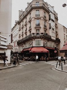 people are walking on the street in front of buildings