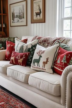 a living room filled with white couches covered in christmas pillows and decorative throw pillows