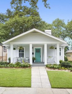 a small white house with a blue front door