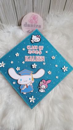 a blue graduation cap with hello kitty on it