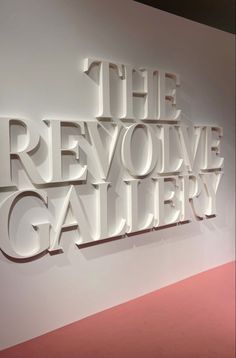 the logo for the revovve gallery is displayed on a wall in a museum