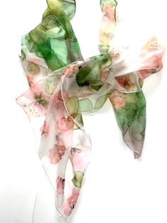 "Silk scarf hand painted pink, green \" Flowers dance \". Woman neck scarf hand painted on silk chiffon silk for SilkStory scarves collection. Delicate pink decorative flowers fit nicely on a white background. The green mossy color of the leaves gives the scarf integrity and the completeness of the composition. Various decorative floral and leaves patterns create a natural feeling of nature. This scarf is painted on fine 100% pure silk (chiffon), and is hand hemmed with silk threads. Size: 18x72 Woman Neck, Gift Idea For Mother, Pink Silk Scarf, Hand Painted Card, Long Silk Scarf, Floral Silk Scarf, Silk Scarf Painting, Hand Painted Silk Scarf, Pink Scarves