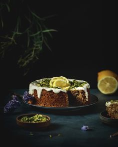 a cake on a plate with lemons and lavender