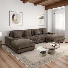 a living room with a large sectional couch and coffee table in the middle of it