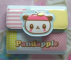 an adorable little panda apple in a plastic case on a pink and white blanket with polka dots