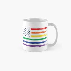 a white mug with an american flag painted on the front and rainbow stripes around it