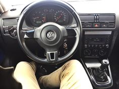 the interior of a car with steering wheel and dashboard