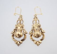 A beautiful large pair of antique Victorian 15k gold dangling pear floral earrings dating to circa 1880. These large and fabulous Victorian solid 15k yellow gold dangling earrings have a classic Victorian hollow construction for wearing comfort and have an unusual design of a wonderful 3D pear fruit with leaves wrapped around the top, framed within a dangling swinging pendulum of scrolls which shimmers and shakes beautifully whenever the head is moved, the pear suspended from a fantastic bouquet Antique Gold Earrings With Historical Design, Antique Drop Earrings With Historical Design, Gold Earrings With Historical Design For Wedding, Antique Wedding Earrings With Historical Design, Vintage Yellow Gold Earrings With Intricate Design, Antique Yellow Gold Earrings For Wedding, Ornate Historical Design Earrings, Antique Yellow Gold Wedding Earrings, Formal Drop Earrings With Historical Design