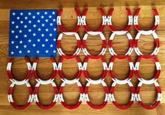 an american flag made out of red, white and blue glasses on a wooden table