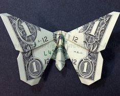 an origami butterfly made out of one dollar bill