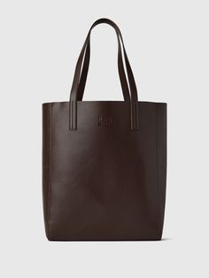 Smooth synthetic leather tote bag.  Shoulder straps at top.  This product was made in a factory that runs the Gap Inc.  P. A. C. E.  Personal Advancement & Career Enhancement) program.  P. A. C. E.  is our educational program that helps the women who make our clothes build the skills, knowledge, confidence & resilience needed to advance in work & life.  Learn more here.  Dimensions: 15"H x 12. 2" W x 5. 1" D Cheap Office Bags With Zipper Closure, Big School Handbags, Affordable Leather Bags For Back To School, Cheap Student Tote Shoulder Bag, Cheap Collegiate Bags For Everyday Use, Cheap Student Laptop Bag, Cheap Leather Tote Bag, Cheap Leather Shoulder Bag For Students, Ralph Lauren Coffee Tote Bag