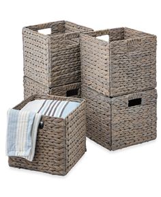 three wicker storage baskets with towels on the bottom and one in the middle, all stacked together