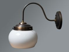 an old fashioned wall light with a white ball on it