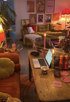 a living room filled with furniture and a laptop computer on top of a wooden table