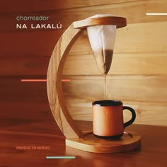 a coffee maker is being poured into a cup on a wooden stand with the words choreador na lakalu above it