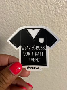 someone holding up a sticker that says wear scrubs, don't date them