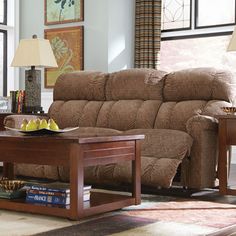 a living room scene with focus on the reclining sofa and coffee table in the foreground