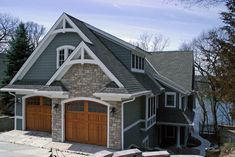 a large house with two garages on the front and one above it's roof