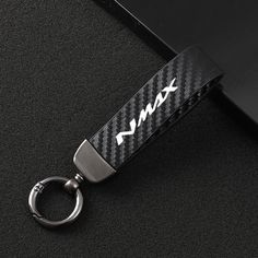 a black and white keychain with the word max on it's side