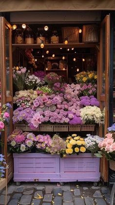 a flower shop with lots of flowers on display