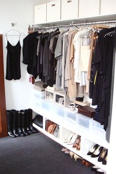 an organized closet with clothes and shoes