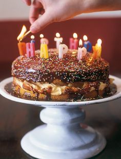 a birthday cake with lit candles on it