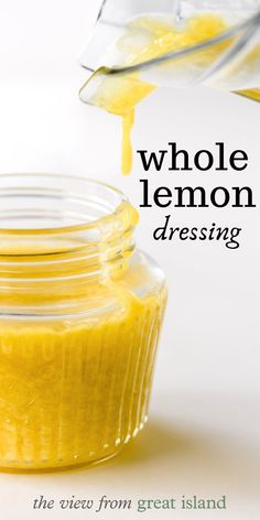 a jar filled with yellow liquid sitting on top of a table