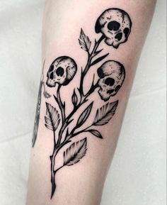 a black and white tattoo with skulls on it