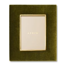 a green frame with the word aerin in gold on it's bottom corner