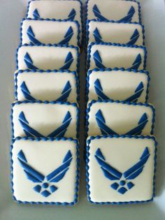 six decorated cookies with blue and white icing