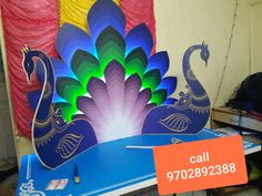 a peacock cut out sitting on top of a table