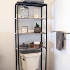 a bathroom with a toilet and shelving unit