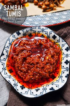 two plates filled with food and sauce on top of each other next to another plate