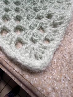 there is a crocheted dishcloth on the counter