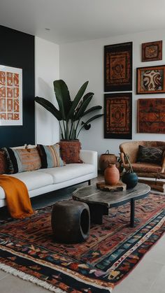 a living room filled with lots of furniture and art on the wall above it's coffee table